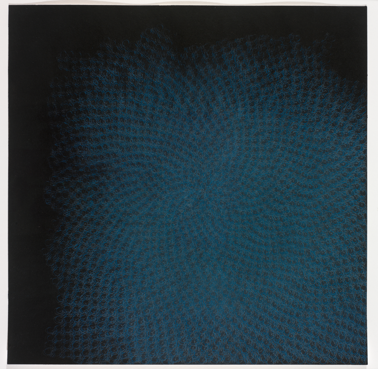 A drawing of blue and graphite concentric circles that spiral outwards from a central point that is slightly off center. It makes the paper look like it’s dissipating.