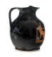 Black vessel with a round body and flared lip connected by a slim handle. The glazed surface is extensively cracked, with orange illustrations of a seated figure on the right.