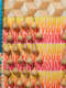 Close up of repeated "STAND YOUR GROUND" text in bright yellow, orange, pink and red, overlaid with rows of hanging gourds and beads.