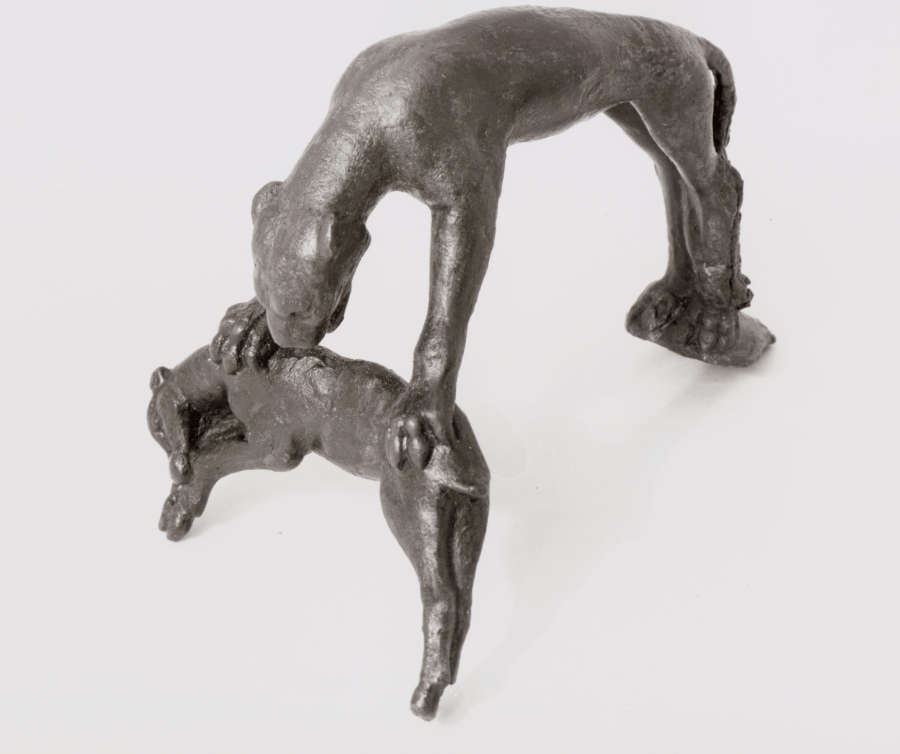 Angled side view of a black metal handle of a leaping panther pouncing and biting a cowering deer. The semi-circular curve of the leaping panther’s body forms a handle.