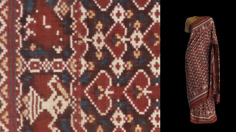 Textile with a dense geometric pattern in dark reds and blues accented by small white squares besides a full-length draped garment made of the same fabric on a black background.