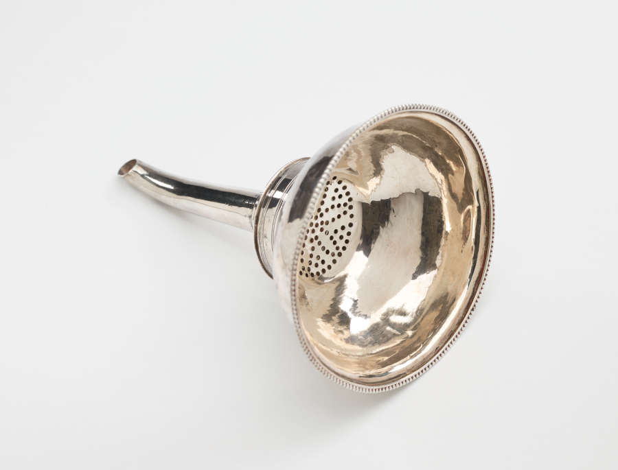 A silver wine funnel with a large cup and small spout.