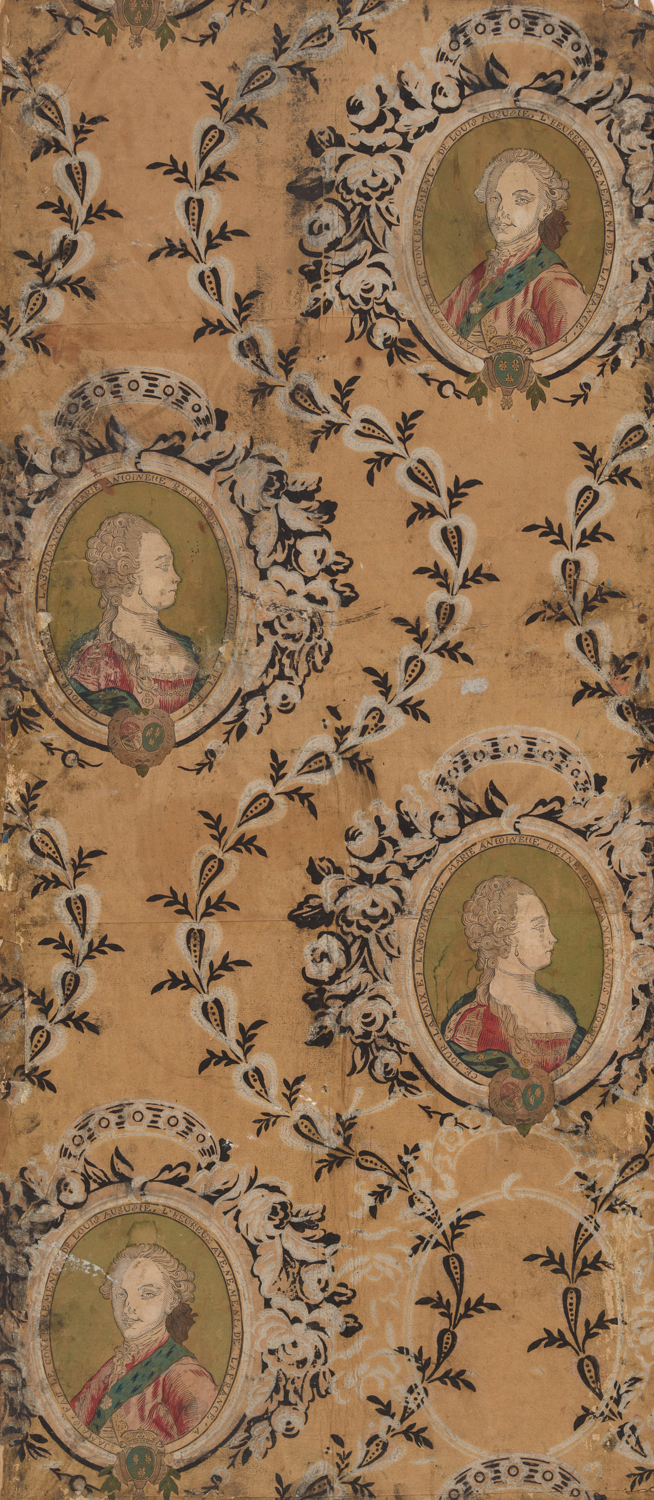 Tan, aged wallpaper of two repeating oval portraits, one of a man and the other a woman, both in elbarote dress encircled by delicate floral wreaths and leafy scrolls. 
