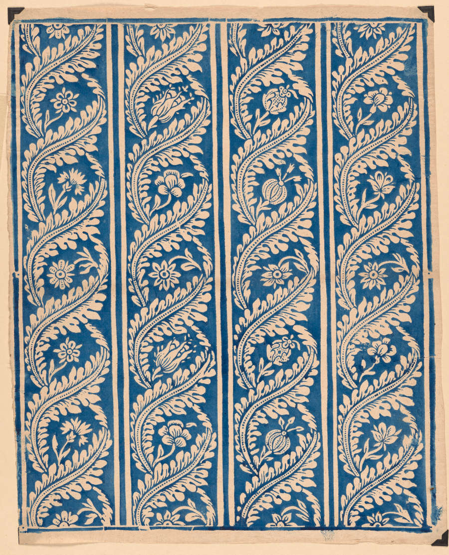 Vintage, classic segment of wallpaper with a blue and white paisley pattern organized in vertical columns. The design features a variety of flowers, with lush vines spiraling around them.