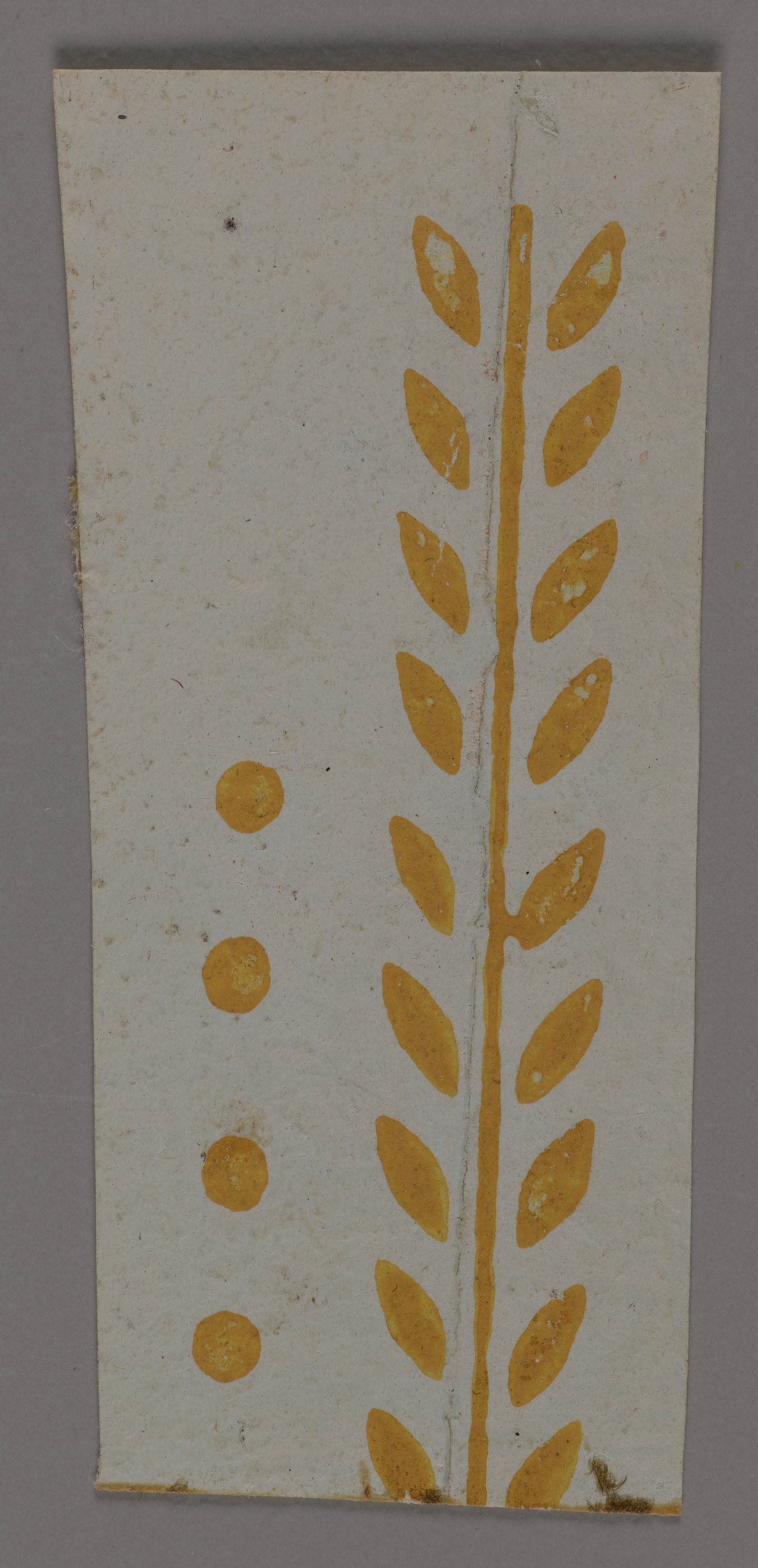 White decorative design element on a gray background with a vertical line of four yellow dots next to a yellow leaf stem design to the right.