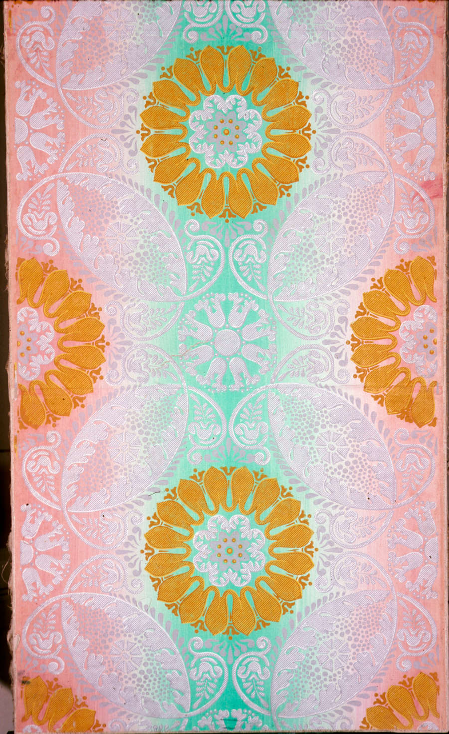 Symmetrical orange medallions reminiscent of mandalas arranged in a diagonal grid atop a psychedelic gradient of mint green and peach.