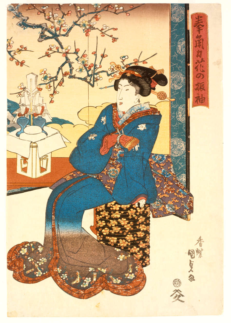 Woodblock print of a seated woman, facing leftwards, wearing an orange-lined teal garment that fades to brown with floral embellishments against a backdrop of blossoming branches and pastel orange clouds.