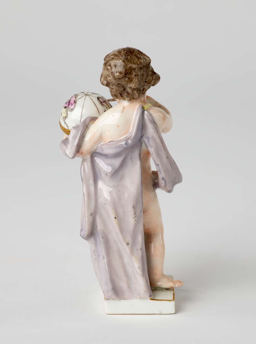 A sculptural putto figure holding a globe banded with gold. The putto has brown hair, red lips, and a light purple fabric draped across their body.