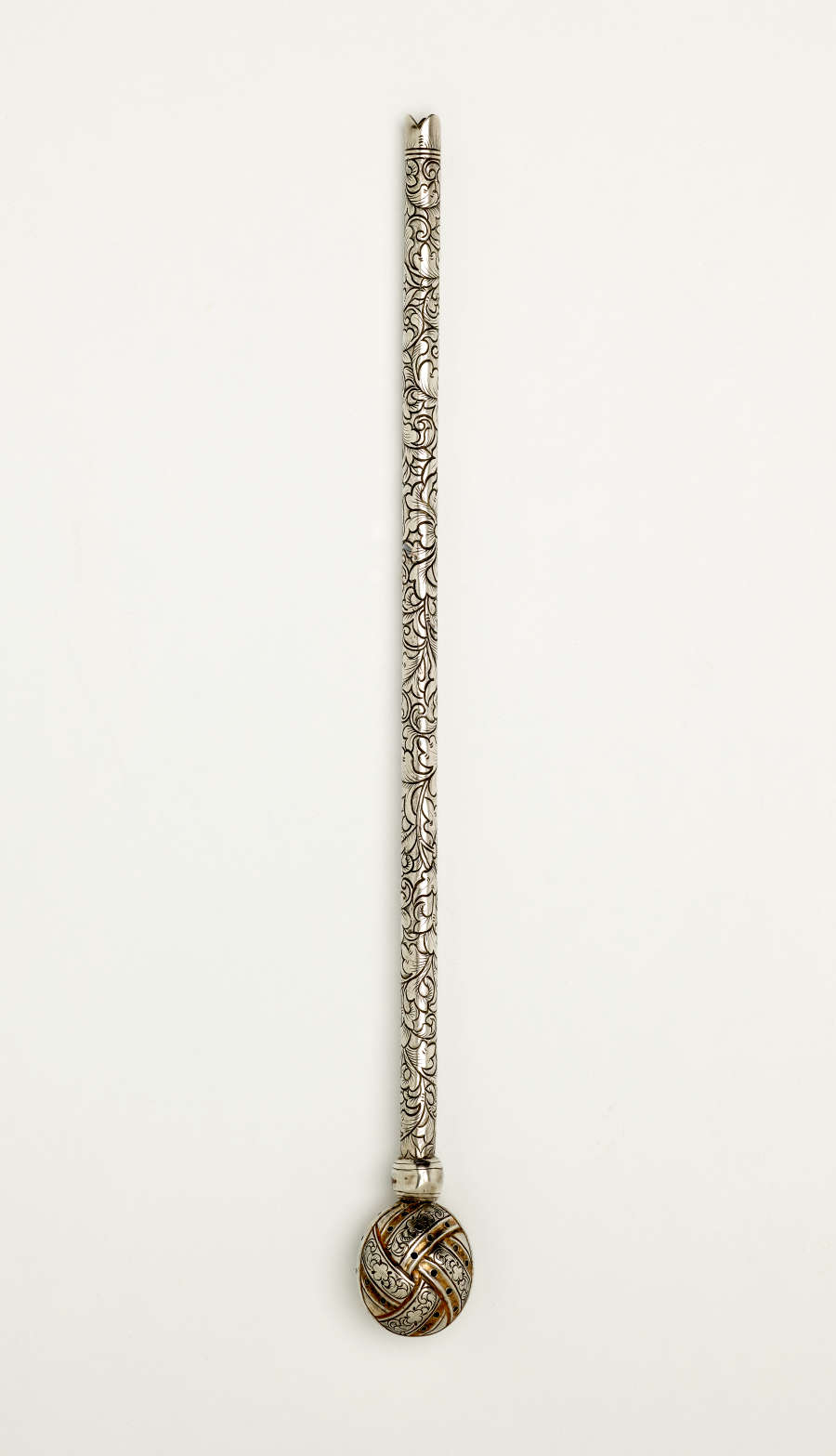  A long silver utensil with a decorative body and has one small bulbous end.