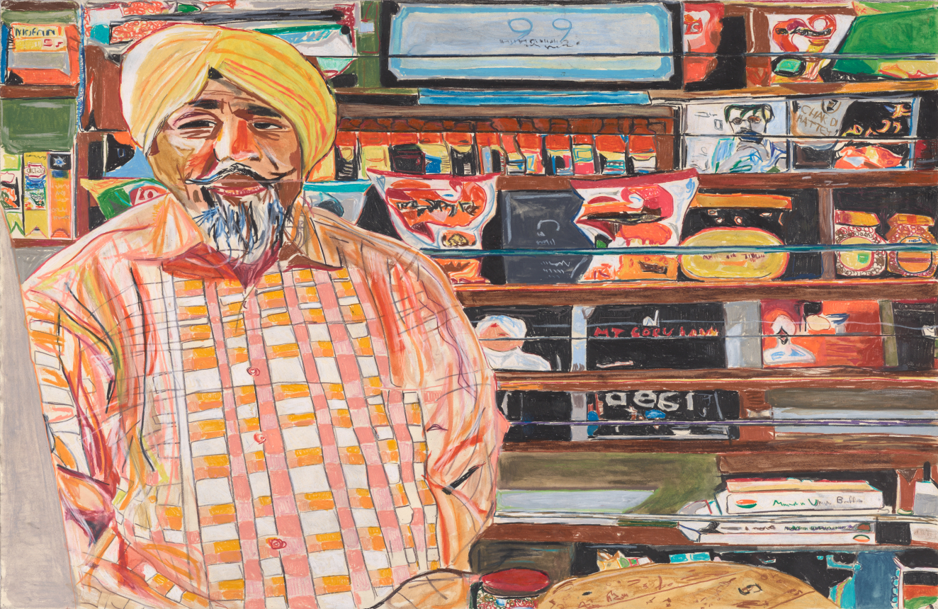 Colorful portrait of a medium-dark-skinned Sikh man wearing a yellow and orange pagri, or turban. Standing at the counter of his deli, with food and convenience items behind him.