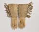 Back of a pair of tan gloves, laid flat, with patterned beaded and fringed edges. Visible are each gloves’ seams and red stitching on the top edges of the cuffs.