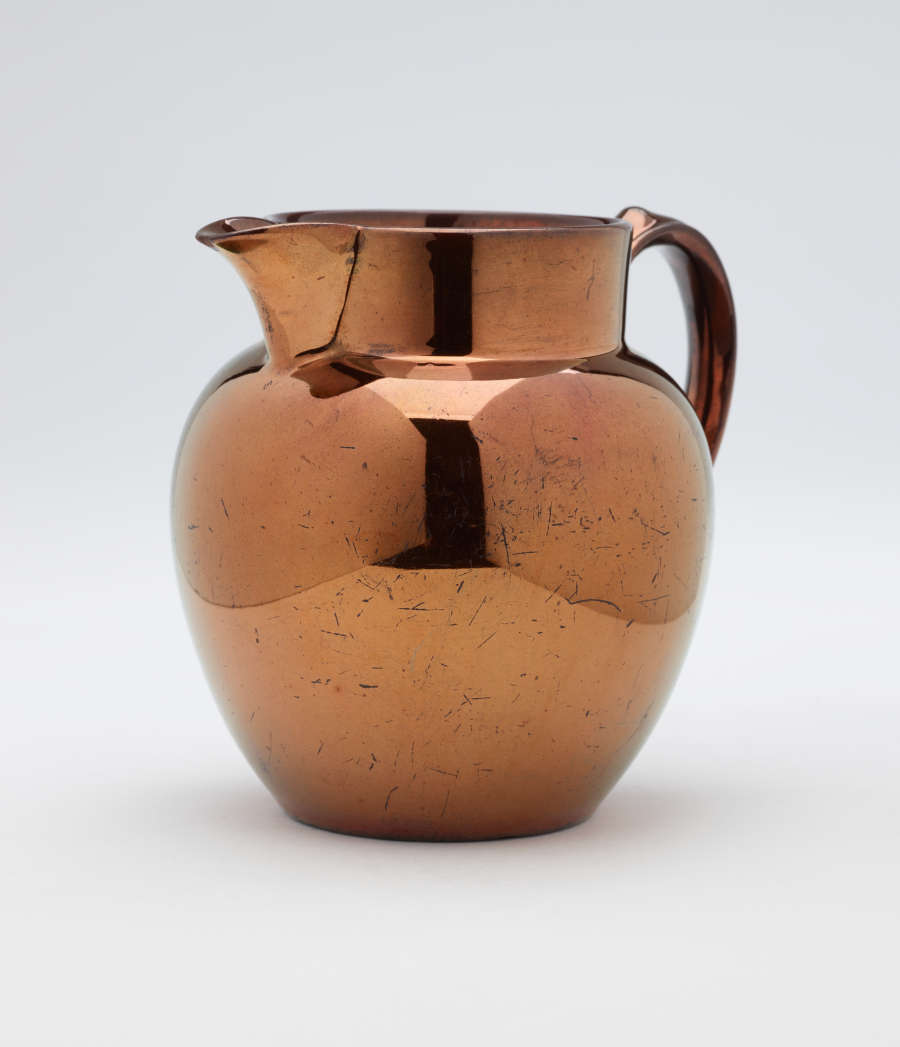 A bronze-colored jug.
