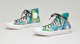 High top sneakers with a bright hand-painted blue and green abstract design and black laces.