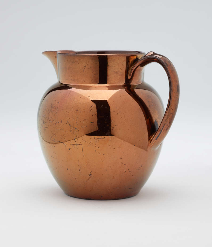 A bronze-colored jug.
