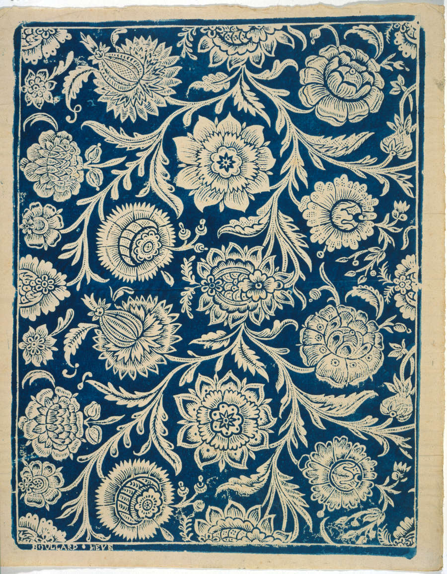 Vintage repetitive wallpaper sample depicting a dense, ornate, blue and cream pattern showcasing paisleys and intricate stylized floral motifs on a rich tan-toned base.