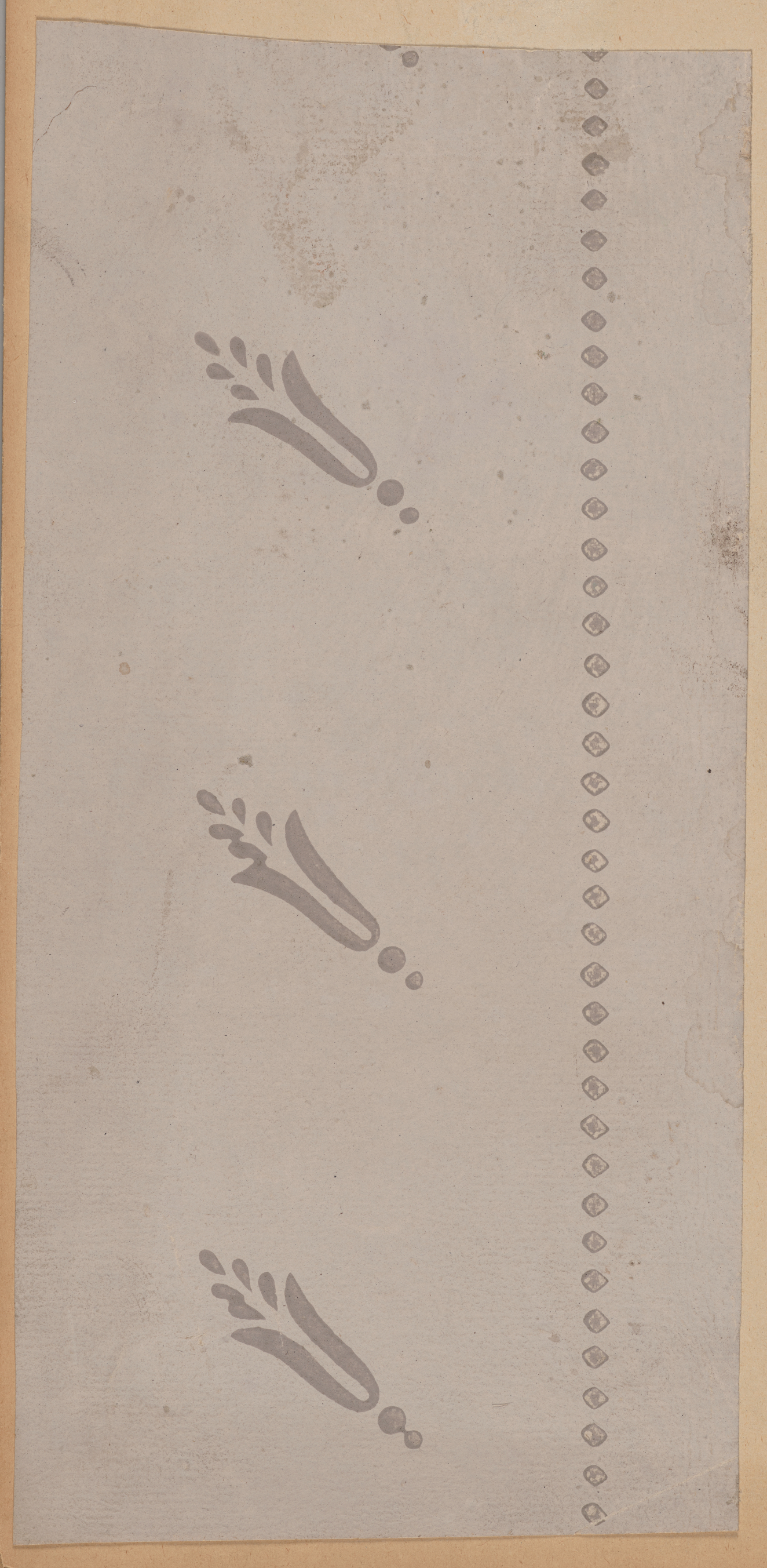 A simple gray rectangle with floral motifs accompanied by a dotted right edge.