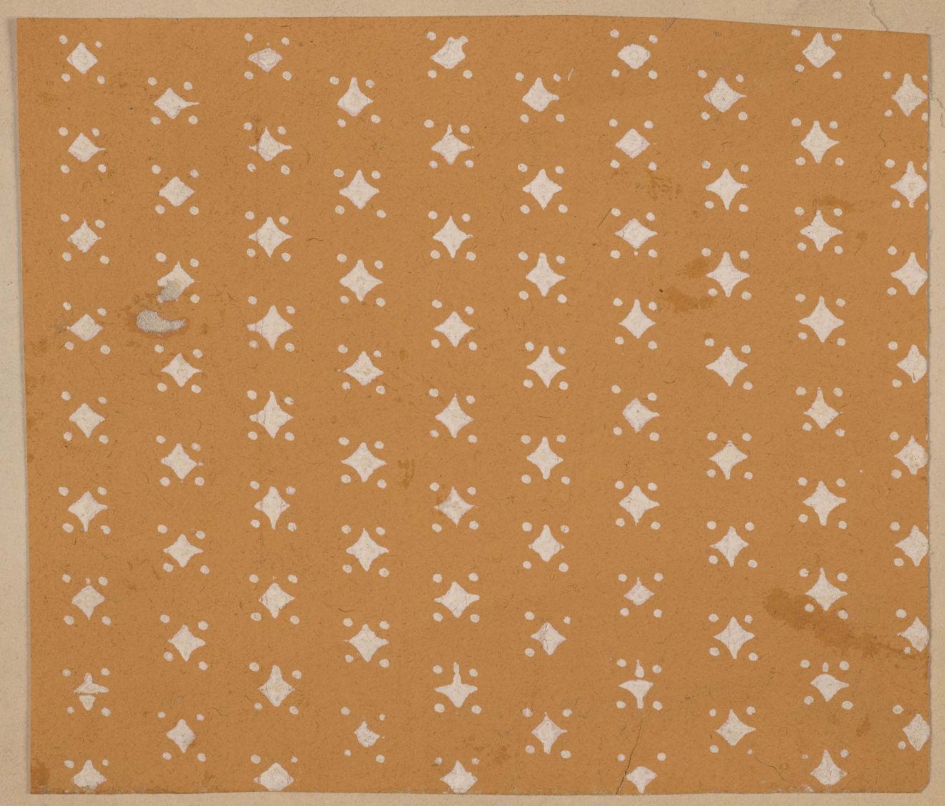 Decorative pattern featuring evenly spaced rows of small diamonds accented by dots on each side to give a star-like effect on a mustard yellow background.