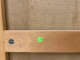 Back of canvas showing horizontal wooden support featuring a green sticker marked “C39” and a visible metal screw fixture.