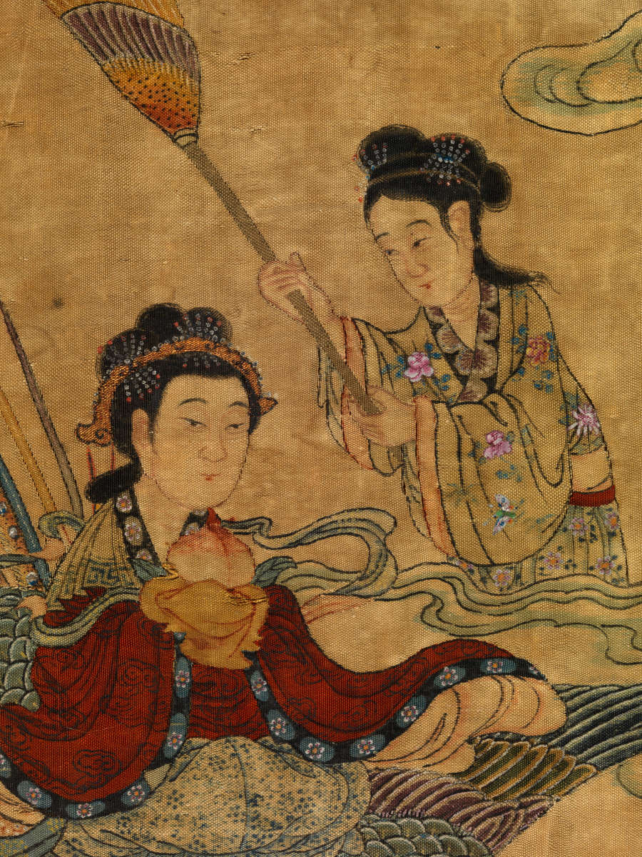 Detail of the scroll showing one seated figure and one kneeling figure holding a broom-like device above the other figure’s head. Both figures are robed.