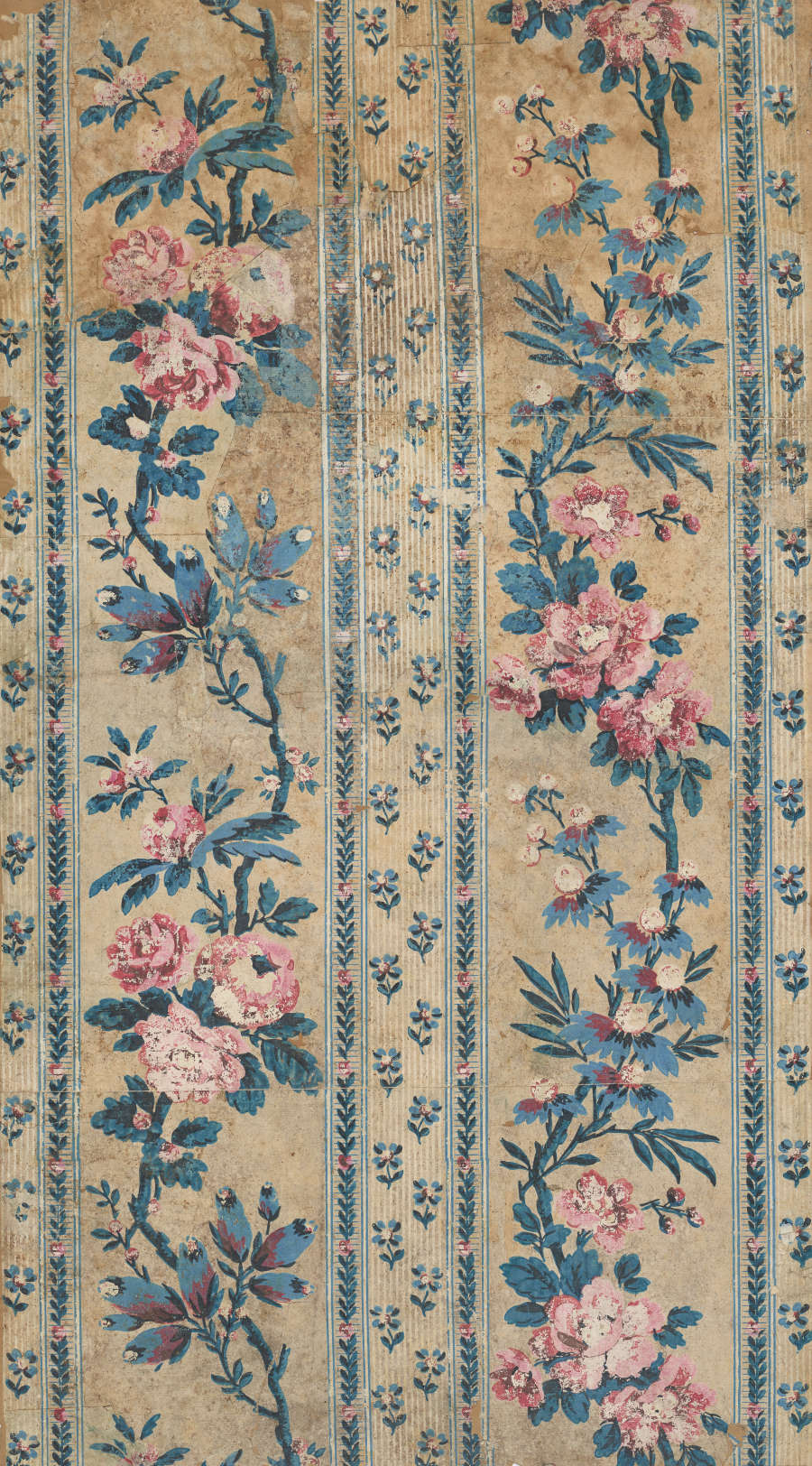 Panel of vintage fabric wallpaper featuring vertically aligned, faded pink and blue garlands alongside patterned columns of small floral motifs. The design is set on a mottled beige background.