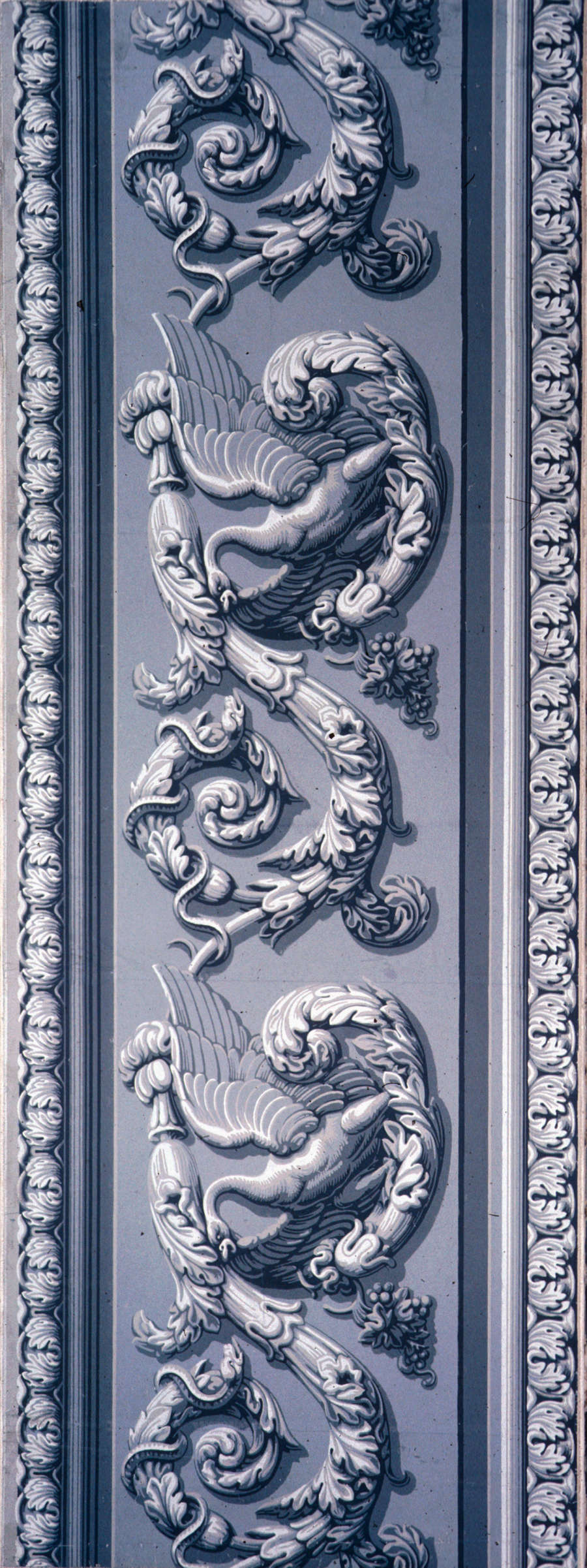 Flat frieze featuring ornate acanthus scrolls, swans, snakes, and floral motifs in a continuous pattern that appears three-dimensional on a neutral background.