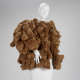 Oversized bulky waist-length brown coat constructed entirely from the plush, dense, soft forms of teddy bears, draped over a white mannequin. 