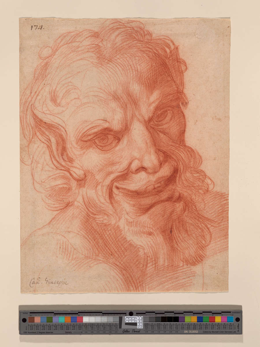 Red chalk drawing of a smiling satyr’s head with delicate marks throughout and vigorous crosshatching at the chest. He has pointed ears and curly hair and beard.
