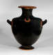 A black glazed vase with three curved handles and minimal orange geometric decorative designs highlighting the edges. 