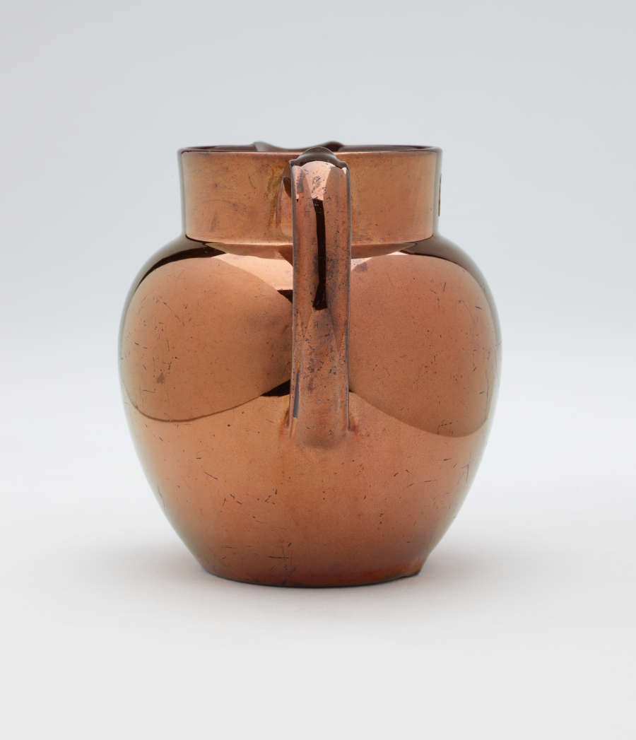 A bronze-colored jug.
