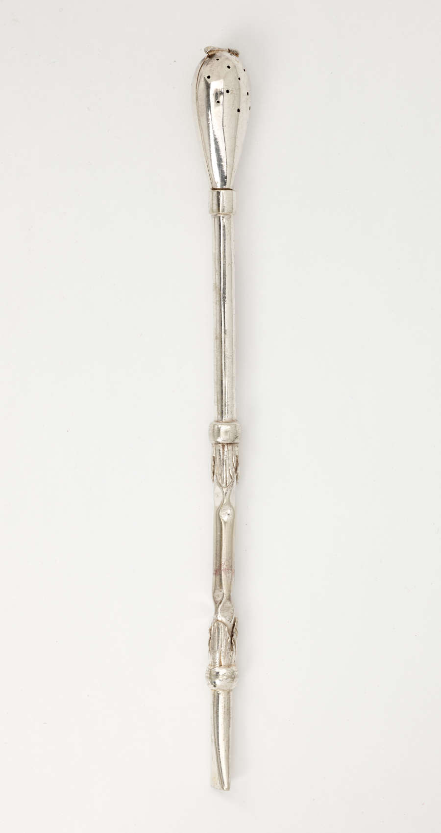 A silver utensil with a long skinny handle and bulbous end with small holes.