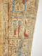 Colorful painted figures with animal heads in vertical rows surrounded by hieroglyphs.