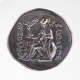 A silver coin featuring a central engraving of a seated figure wearing a helmet, propped on a shield, holding a small winged figure, with Greek inscriptions framing the design.