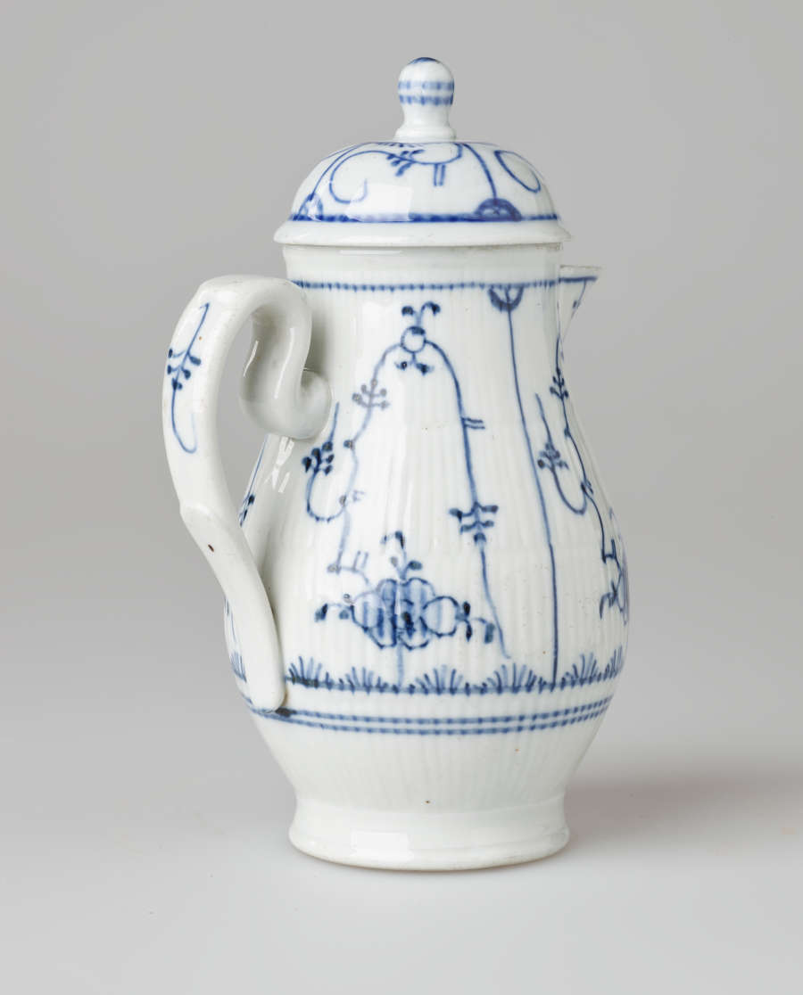 A white chocolate pot with delicate blue decorations with ribbed body, spout, handle, and foot.