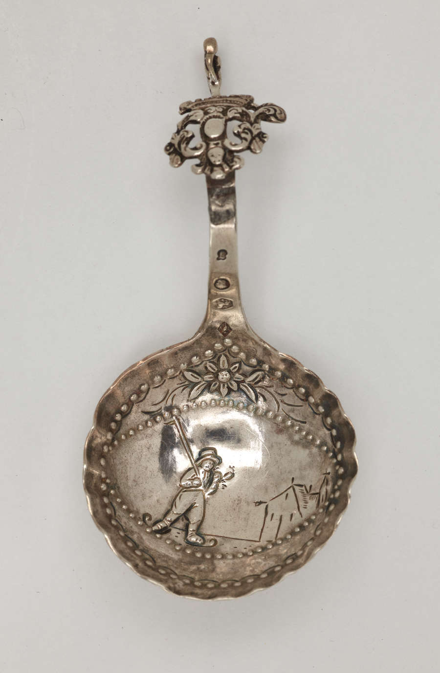  A silver caddy spoon with figurative and sculptural elements.