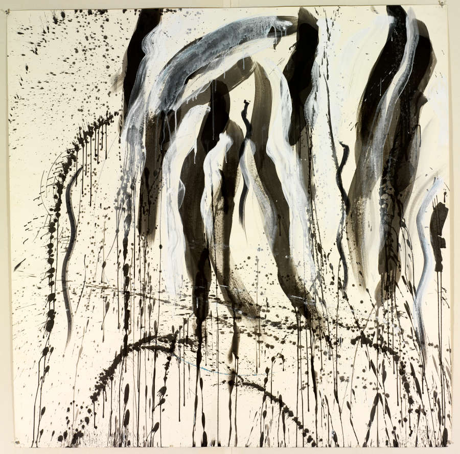 Vertical streaks of white and black paint on off-white paper. Drips and splatters of black paint on the page as well.