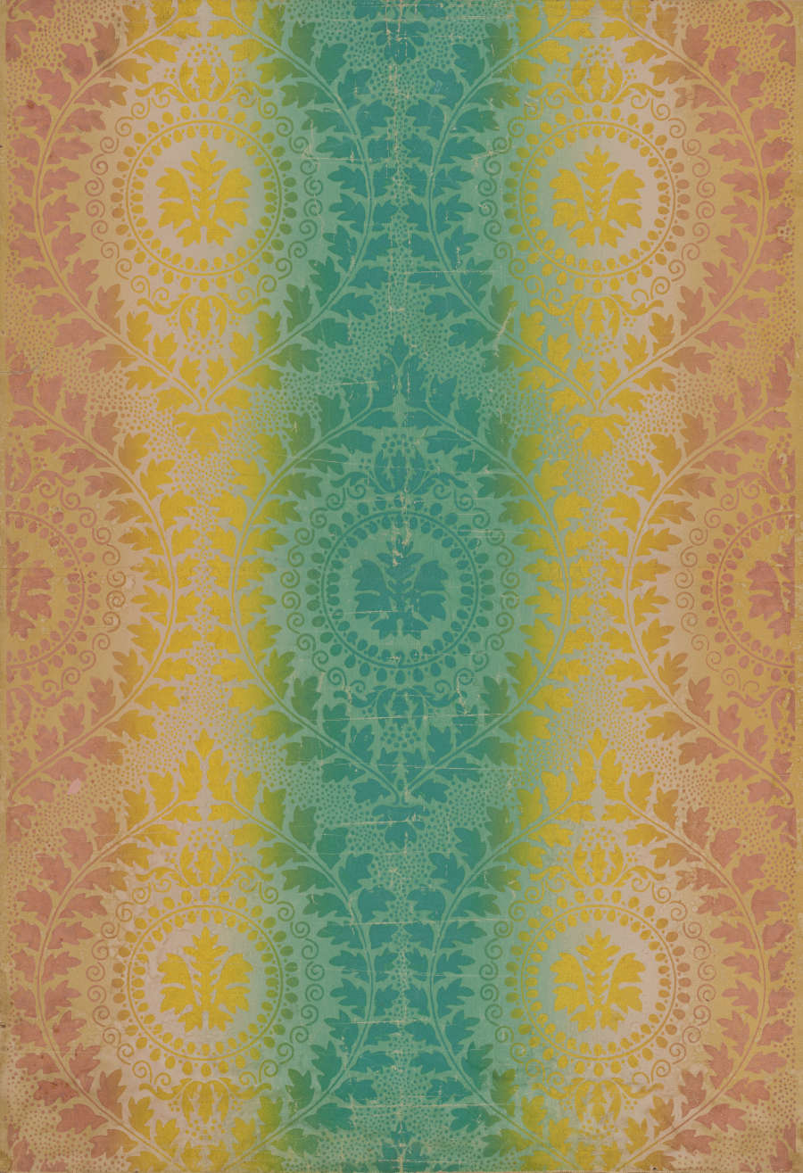 Wallpaper featuring detailed mandalas made of leaf and foliage designs that transition from a muted orange, to sunny yellow, to a cool teal at the center.