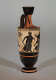 Tall, narrow black and orange vase with a looped handle at the base of the thin, fluted neck. Visible is the black illustration of a cloaked man holding a branch.