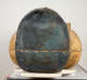 The top of a coffin's head, painted in blue-black with cracks and a horizontal seam across the center.