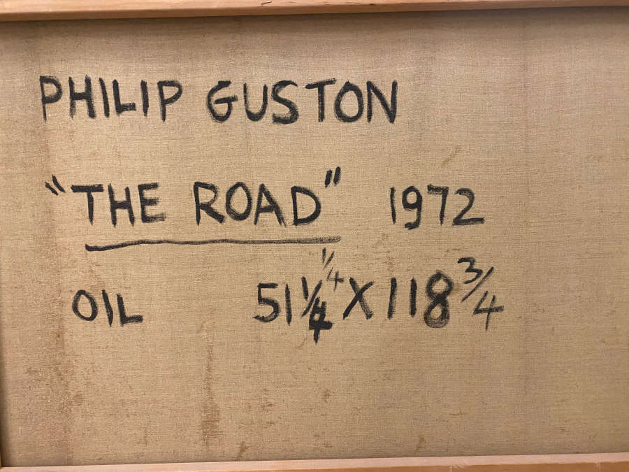 Back of a canvas with handwritten black text on raw fabric reading “Philip Guston,” “The Road,” “1972,” and “Oil 51¼ × 118¾.”