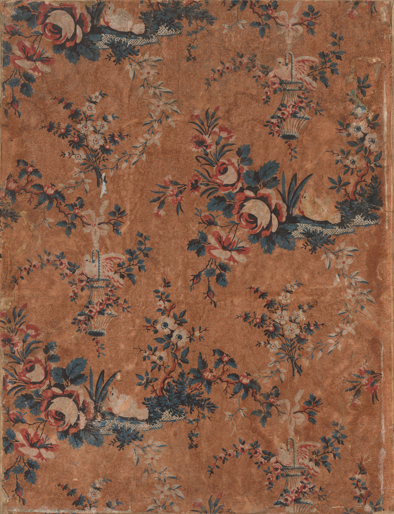 Aged, rust-toned floral wallpaper containing birds atop tiny silver bird cages surrounded by various sized groups of light pink and white roses with dark blue leaves attached to them throughout.