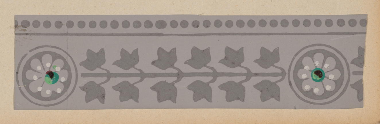 A horizontal decorative gray border with a repeating leaf pattern flanked by circular floral motifs with green centers, and a row of small dots along the top.