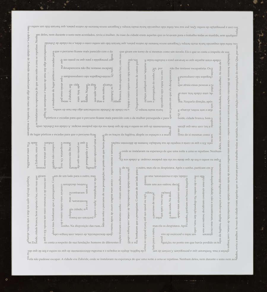 Perfectly even maze-like geometric design on white. The design looks gray, but closer examination shows that it’s actually text.
