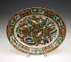 An oval serving dish. Decorated in the center with multicolored butterflies.