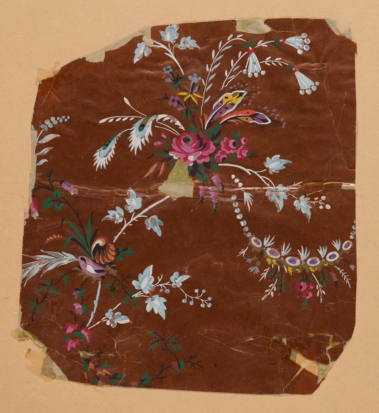 Crinkled, brown wallpaper with torn, taped edges, pink and purple flower bouquets with multicolored feathers, against a tan background.