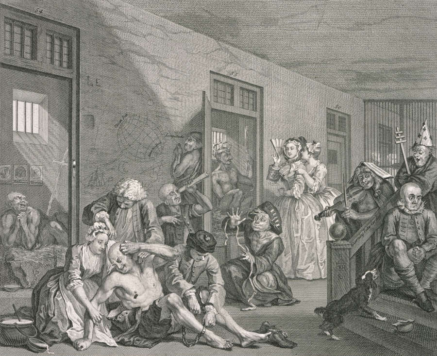 Realistically rendered etching of a cast of characters inhabiting an 18th-century mental institution. The room is populated with institutionalized men, while two upper-class women shield their eyes with fans.