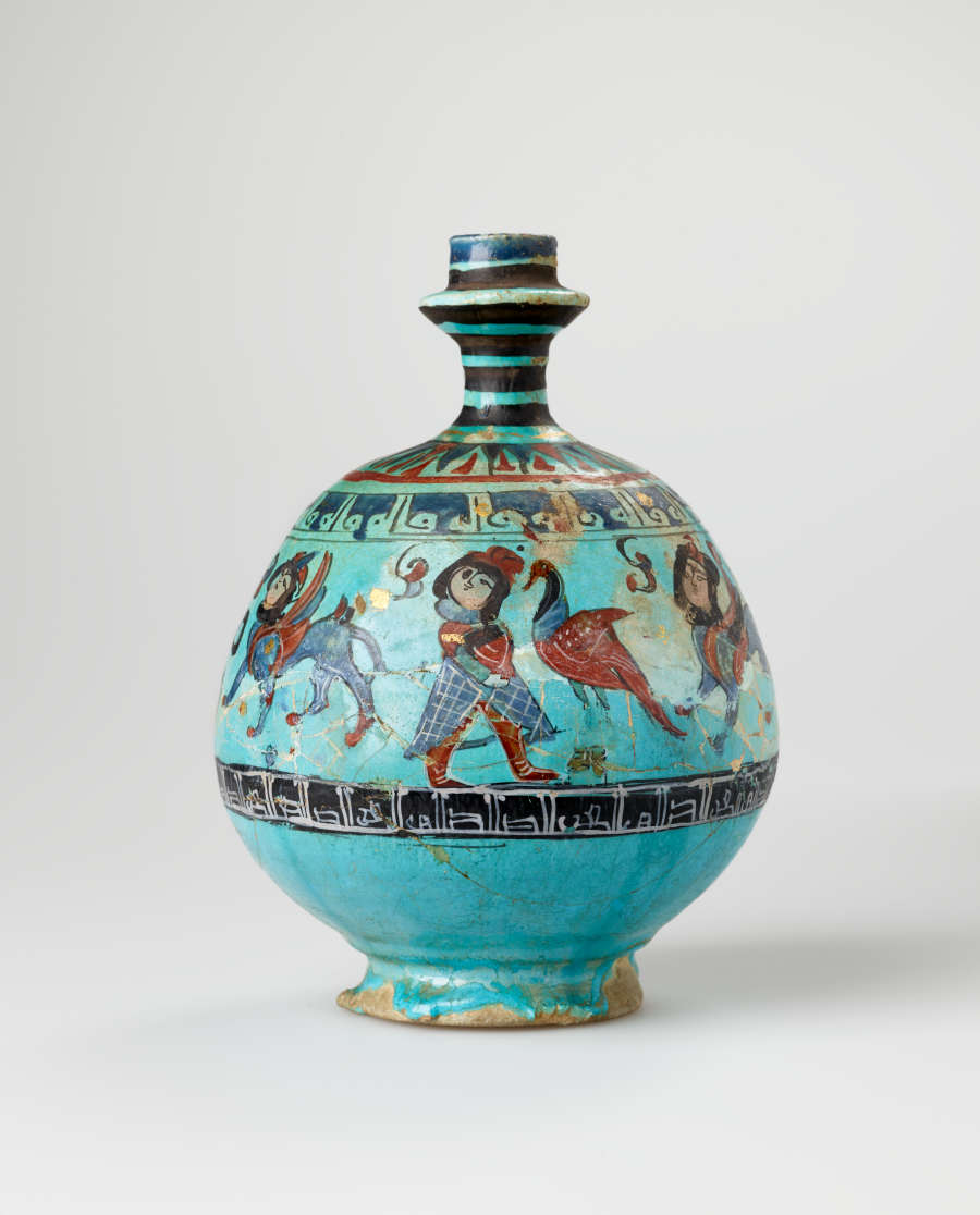 Turquoise jug with a spherical body and slender neck. The jug’s body is decorated with illustrations of winged humanoid four-legged creatures and dark patterned stripes.  It’s handle is not visible.