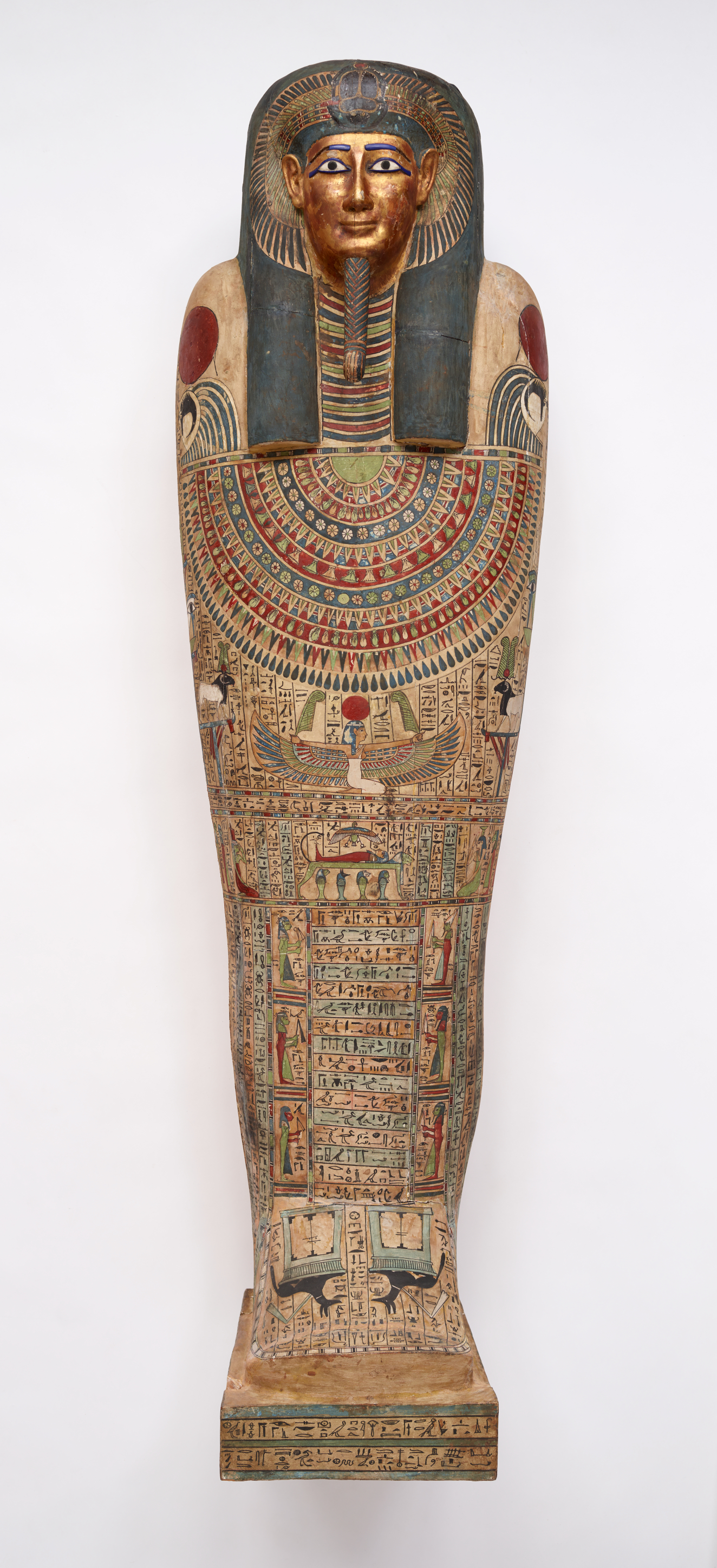 A vividly decorated coffin with hieroglyphs, symbolic imagery and a gilded face framed by a painted black wig.