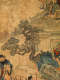 Detail of the scroll showing two figures standing in the bottom-left, while an ornate bonsai-like tree extends from the bottom-right into the center. In the background is an ornate balcony.