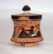 A small, flared, terracotta container with a black-glazed lid, adorned with black figures in flowing robes, holding instruments.