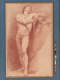 Red chalk drawing of a male nude. With elbow atop a tall draped pillar, he clasps his right wrist with his left hand, tipping his head back to gaze upwards.